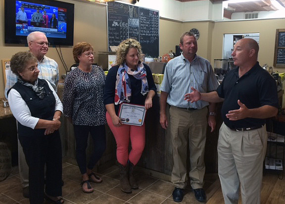 Elkton Mayor Robert J. Alt, far right, meets with the owners of The Coffee Place as the town's historic downtown business district commemorates Economic Development Week.
