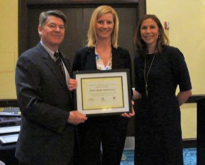 Secretary Kenneth C. Holt and Assistant Secretary Tiffany Robinson present Heidi Ford of First Home Mortgage (center) with the award for Top Producing Lender.