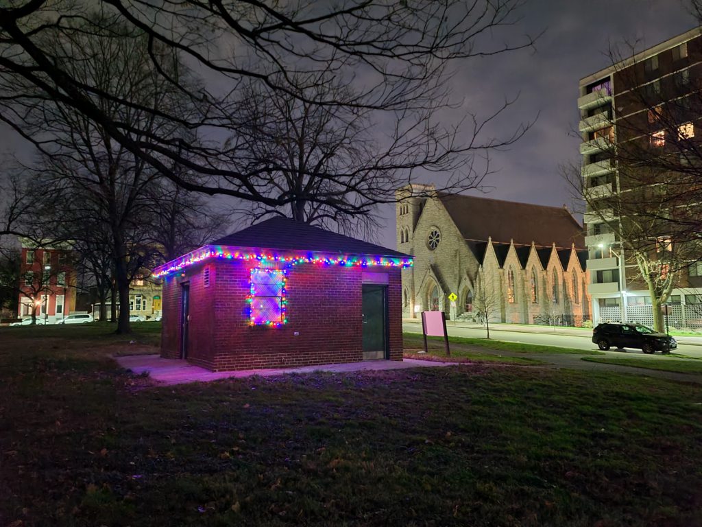 The renovated comfort station at Lafayette Square park is decorated in holiday lights.