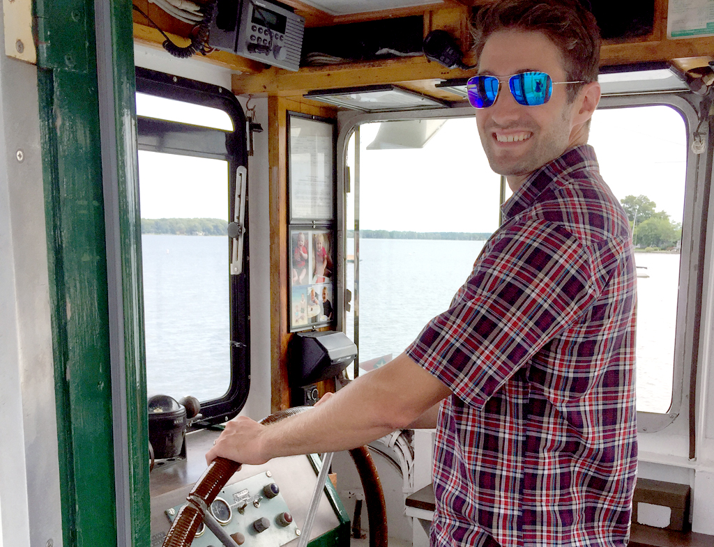 Photo of: Isaac steering a boat