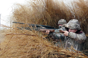 Photo of: Women hunting from tall grass