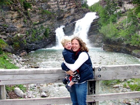 Photo of Dana Reiss and child in front of waterfall