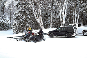 Photo of: Snowmobilers leaving parking lot