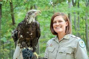Photo of: Ranger with eagle perched on her arm