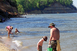 Photo of people looking for fossils on beach