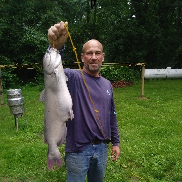 Photo of man with record-setting white catfish