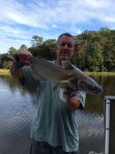 Photo of Man holding channel catfish