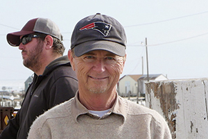 Photo of smiling man in baseball cap