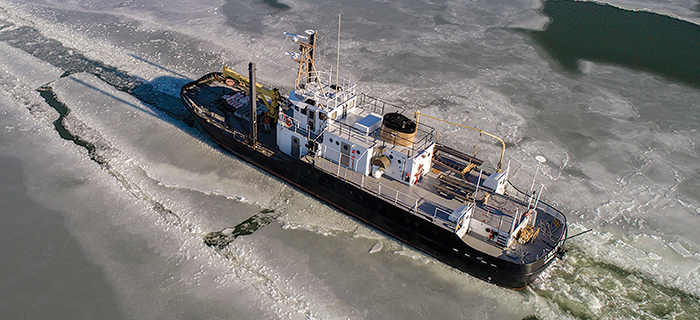 photo of large ship breaking ice on bay