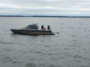 Photo of Natural Resources Police divers at work off Kent island. 