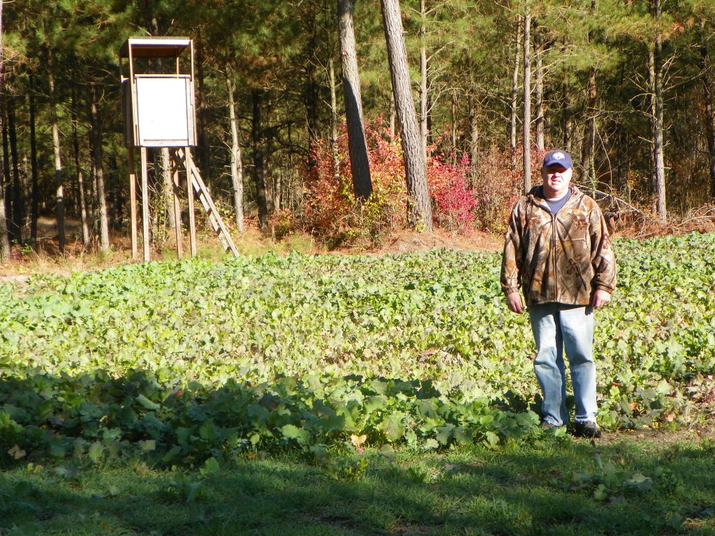 Photo of landowner standing by his Tree Farm forest stand