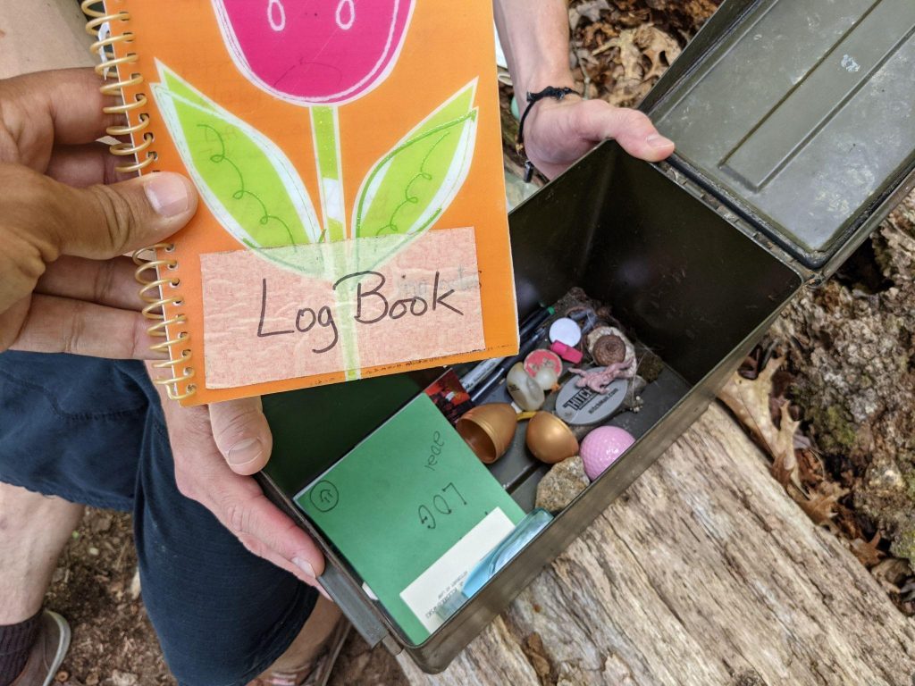 Photo of a log book and geocache