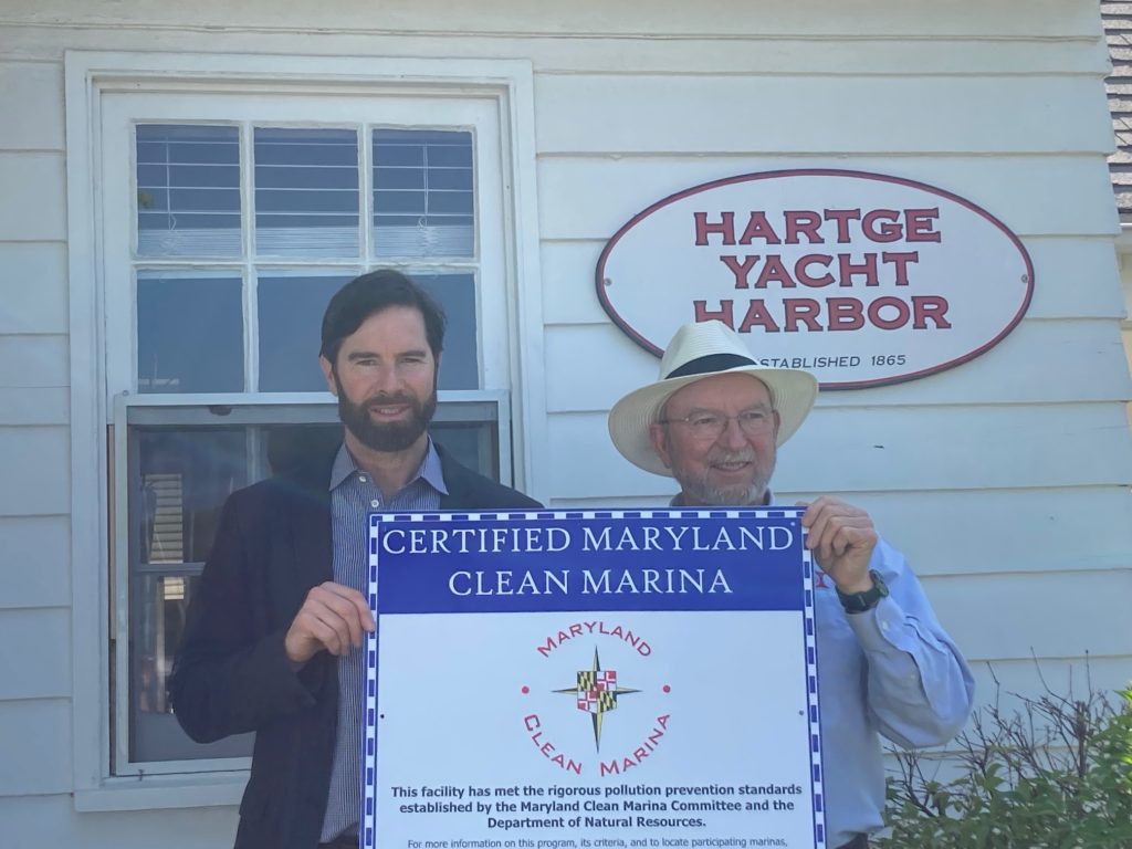 Photo of two men holding a Clean Marina sign