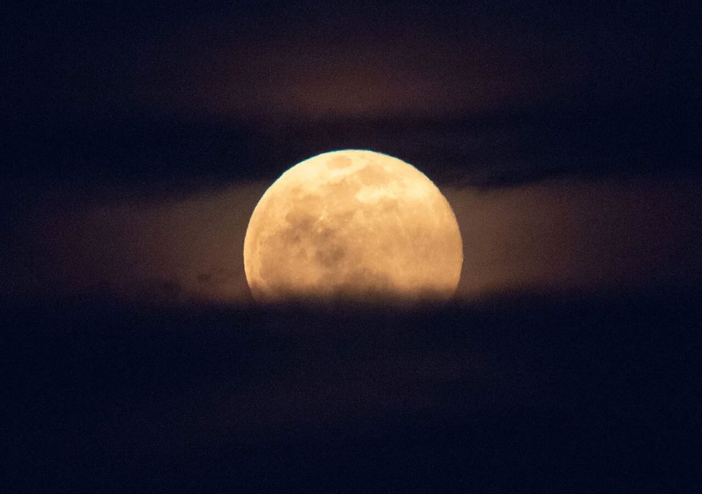 Full Moon, Hunter's Moon rising out of the clouds