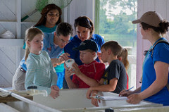 kids testing water with scientists