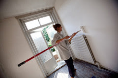 A woman painting the inside of a house