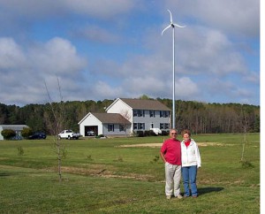 man on his property with wind turbine