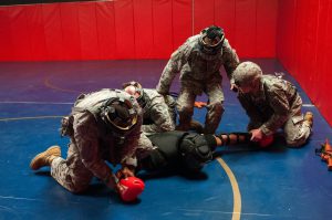 Students practice combatives techniques and maneuvers during the Tactical Combatives Course on May 24, 2016, at Camp Fretterd Military Reservation in Reisterstown, Md. During the 10-day course, the students are put into possible real-life scenarios so they can use their tactical combatives techniques in order to control the situation and subdue the enemy. (Photo by Spc. Brianna Kearney, 29th Mobile Public Affairs Detachment)