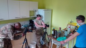 Staff Sgts Michael Davis, Jr., and Margaret Taylor, members of the 29th Mobile Public Affairs detachment, prepare the lab scene of the awareness video. The U.S. Army European Command's Humanitarian Mining Action program brought the Estonian Rescue Board and Maryland National Guard Soldiers together to create public service announcements. The purpose of this project is to raise awareness of and educate the public about the unexploded ordnance issue in Estonia.