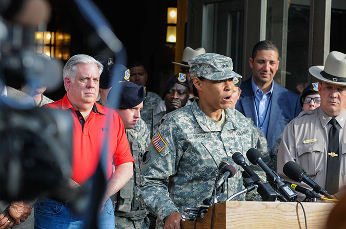 Maryland Gov. Larry Hogan eats dinner with a few members of the Maryland National Guard and afterwards gives a press conference along with the adjutant general of Maryland, Maj. Gen. Linda L. Singh, in front of the 5th Regiment Armory in Baltimore, Md., April 29, 2015. (Photo by Staff Sgt. Michael E. Davis Jr., Maryland National Guard Public Affairs Office)