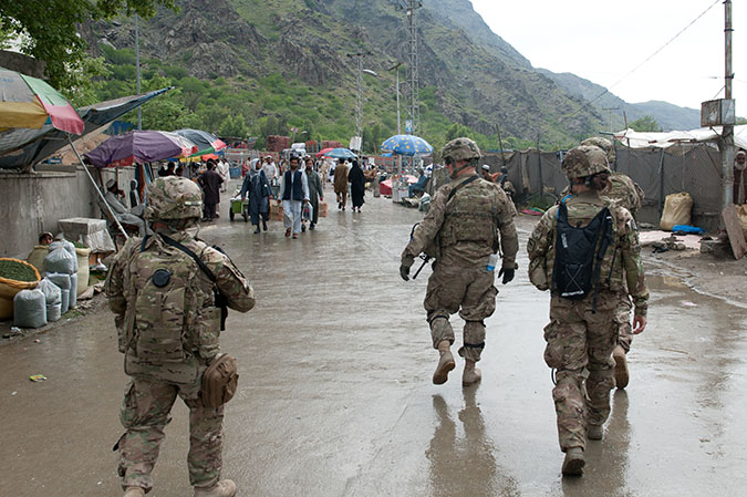U.S. Army Soldiers from 327th Infantry Regiment, 101st Airborne (Air Assault) Division assist Afghan forces secure the customs checkpoint at Torkham Gate, Afghanistan, April 24, 2013. Though women are still not yet fully integrated into combat units, women are not absent from the frontlines. Many fields in the Army, such as public affairs or linguistics, send women to the front where they embed with line units and share the risk. (Photo by U.S. Army National Guard Spc. Margaret Taylor, 129th Mobile Public Affairs Detachment)
