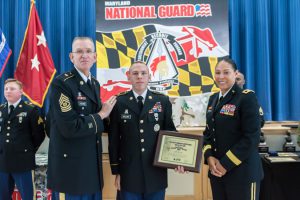 Staff Sgt. Andrew Cullum, Recruiting Retention Battalion, recieves the award for non-comissioned officer of the year after Maryland's Best Warrior Competition. Presenting the award is Command Sgt. Maj. Thomas Beyard and Maj. Gen. Linda Singh, adjutant general of Maryland. The 2016 Best Warrior Competition takes place at Aberdeen Proving Ground, Edgewood, Md., and Gunpowder Military Reservation, Glen Arm, Md., from March 10-13, 2016.Reservation, Glen Arm, Md., on March 10-13, 2016.