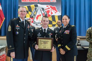 Spc. Christopher Hoffman, C Co., 1st General Support Aviation Battalion, 169th Aviation Regiment, recieves the award for soldier of the year after Maryland's Best Warrior Competition. Presenting the award is Command Sgt. Maj. Thomas Beyard and Maj. Gen. Linda Singh, adjutant general of Maryland. The 2016 Best Warrior Competition takes place at Aberdeen Proving Ground, Edgewood, Md., and Gunpowder Military Reservation, Glen Arm, Md., from March 10-13, 2016.