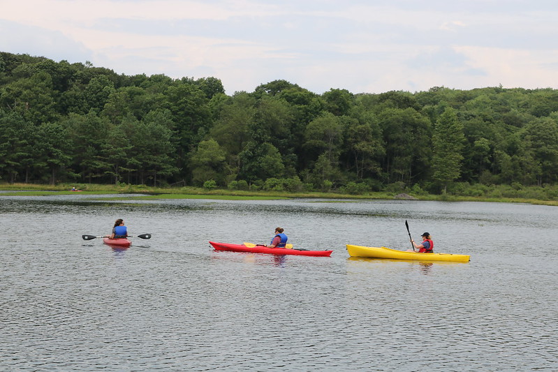 Three women kayaking on a lake in Maryland