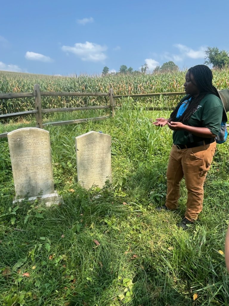 Woman at gravestones in a rural area