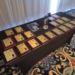 A table that displays award plaques for awardees at the day of celebration.