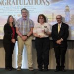 Marilyn Farndon Excellence in Training Awardee, Antonella Volpe stands with three others as shee ois presented her award.